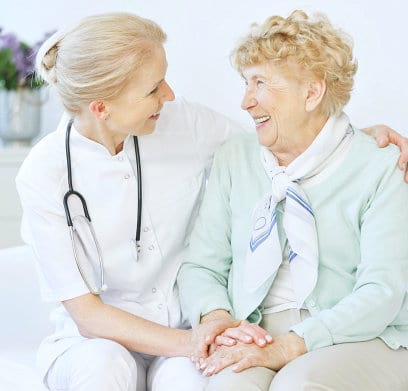 nurse and an elder woman smiling